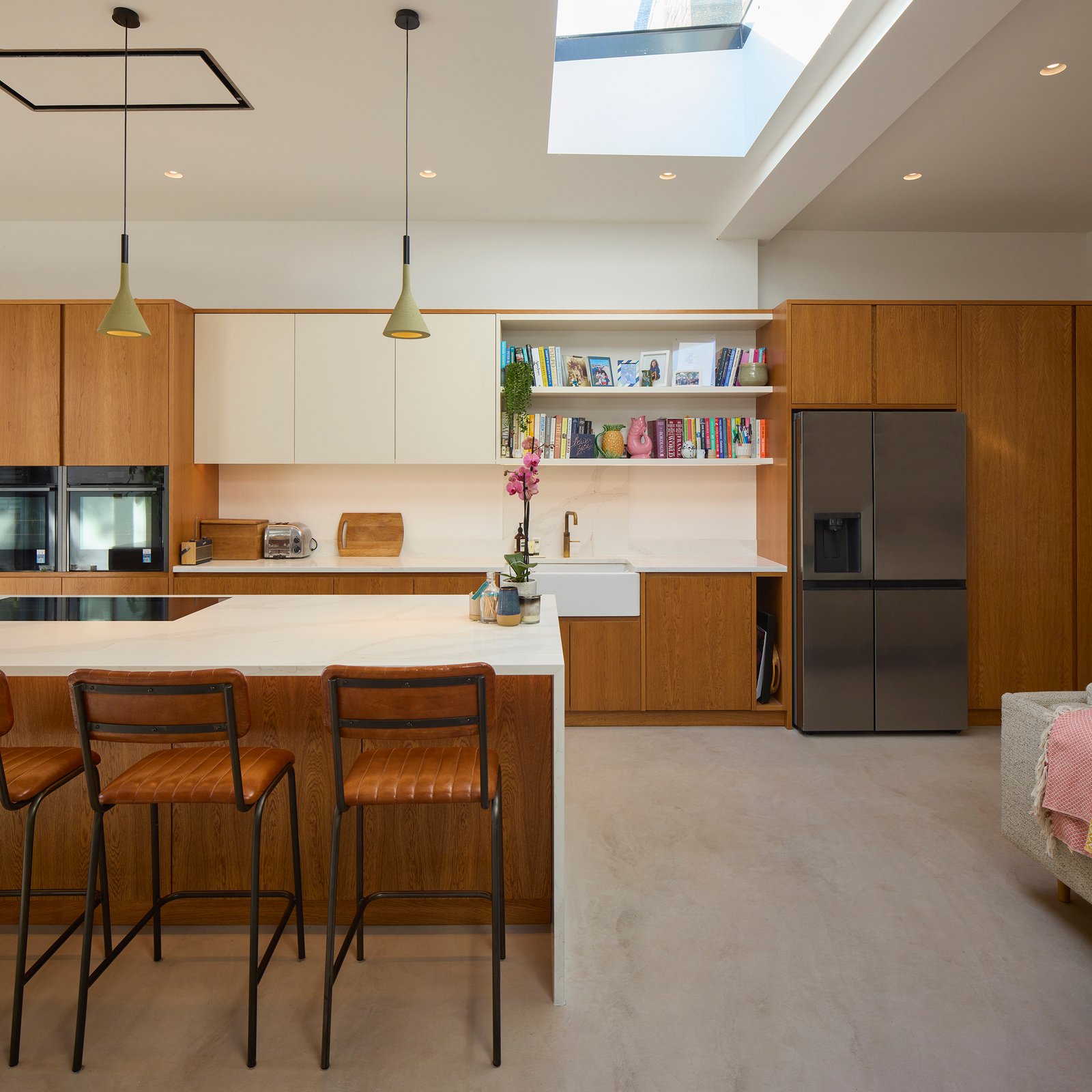 Open-plan kitchen and dining area with skylight and timber finishes