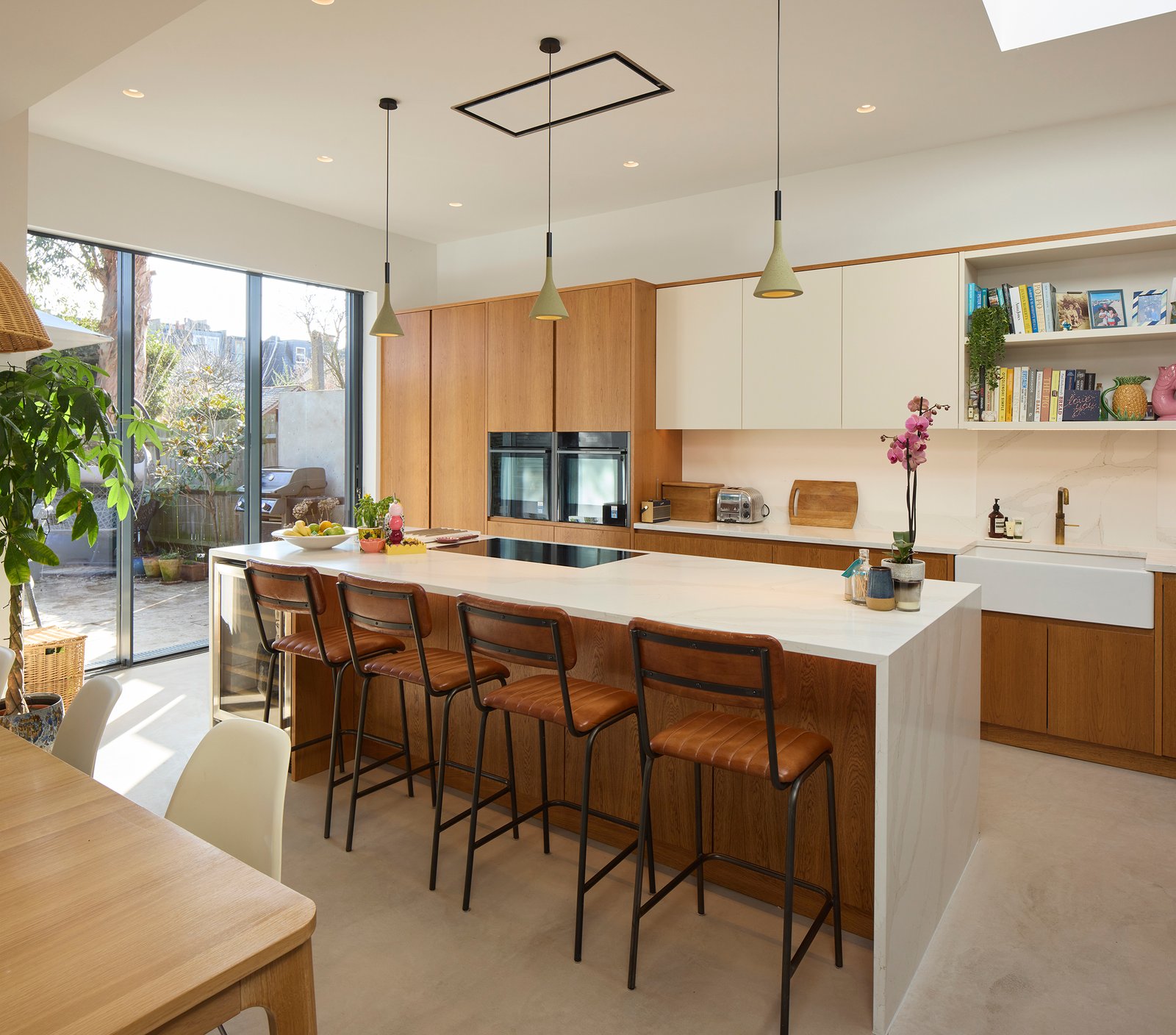 Contemporary kitchen with island, timber cabinetry and skylight