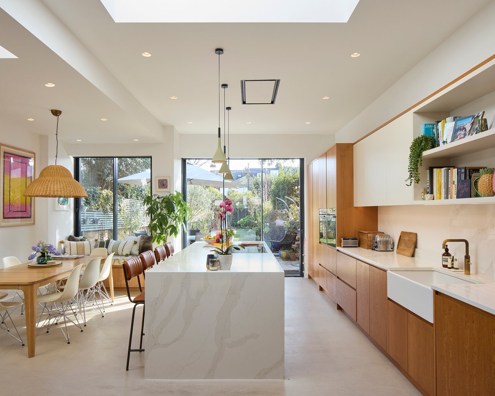 pen-plan interior view through kitchen and living spaces with large glazed openings