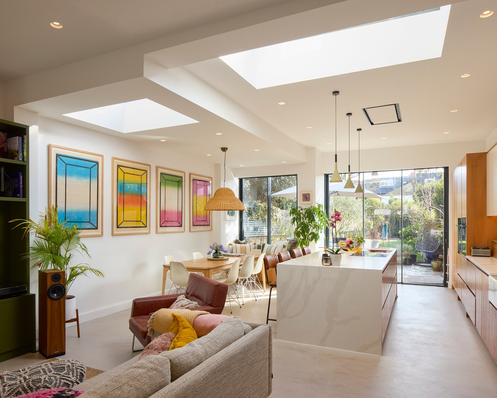 Open-plan interior view through kitchen and living spaces with large glazed openings